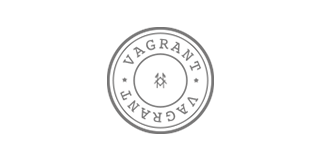 Logotipo circular con la palabra VAGRANT en letras mayúsculas alrededor de un asterisco en el centro.