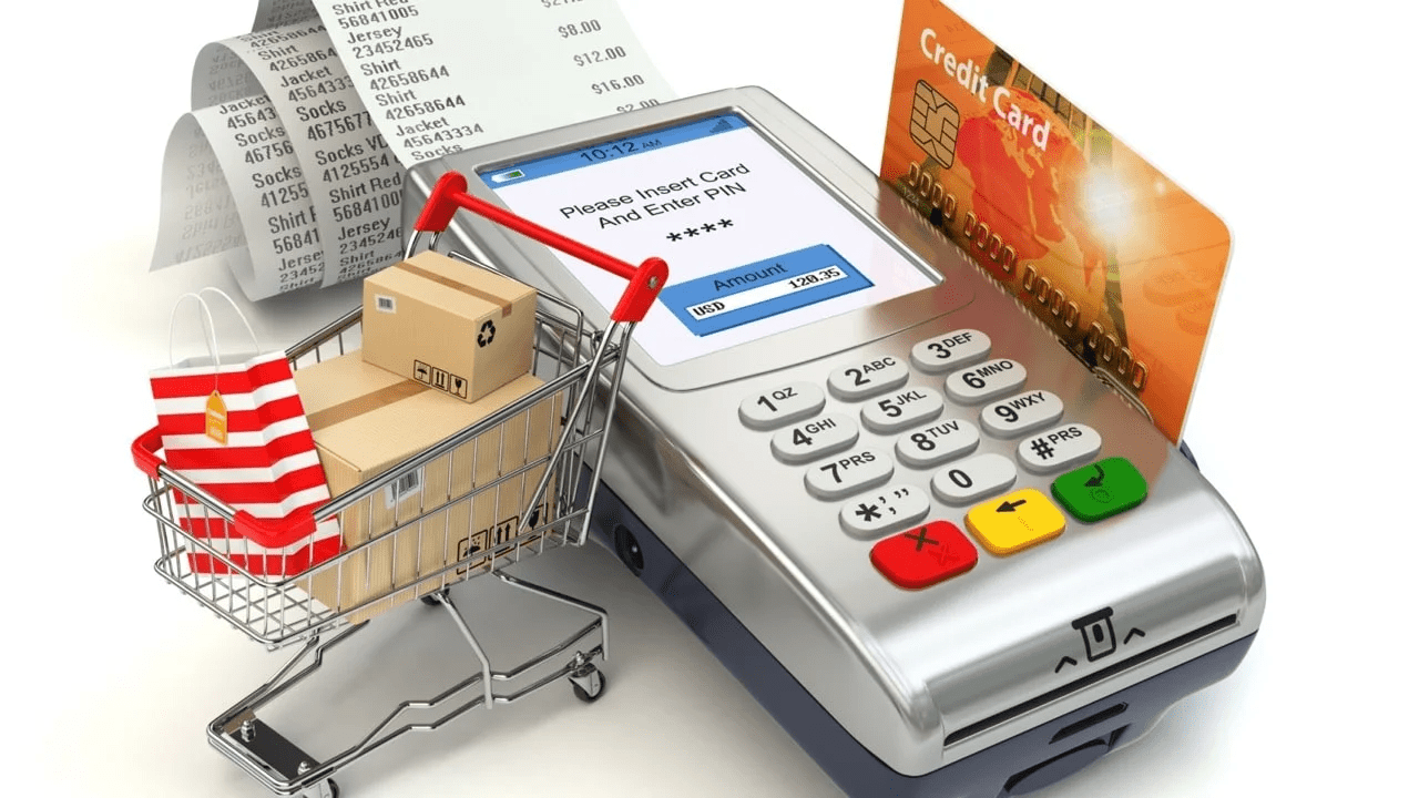 Imagen de terminal de pago con carrito de compras, tarjetas de crédito y recibos, representando compras y transacciones.